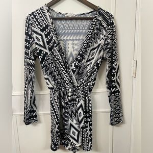 Long sleeve, plunge neck, shorts romper. Black and white pattern